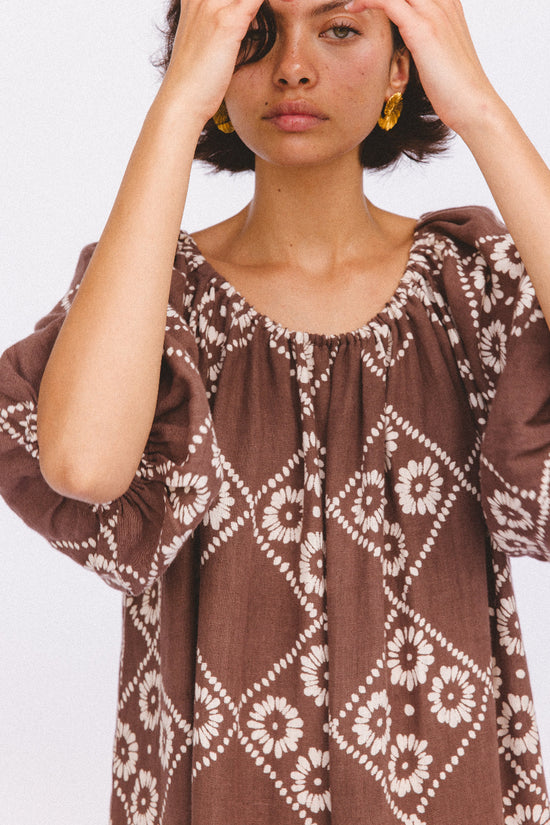 Dahlia Maxi Dress Maple — close-up neckline and sleeve detail, studio portrait, showing billowy hand block print linen fabric with white daisy diamond print | Daughters of India
