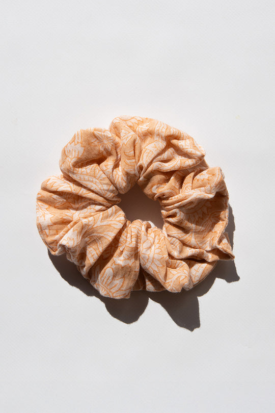 Daughters of India Upcycled Scrunchie in Apricot Blush, a soft peach-orange hair scrunchie made from upcycled cotton fabric