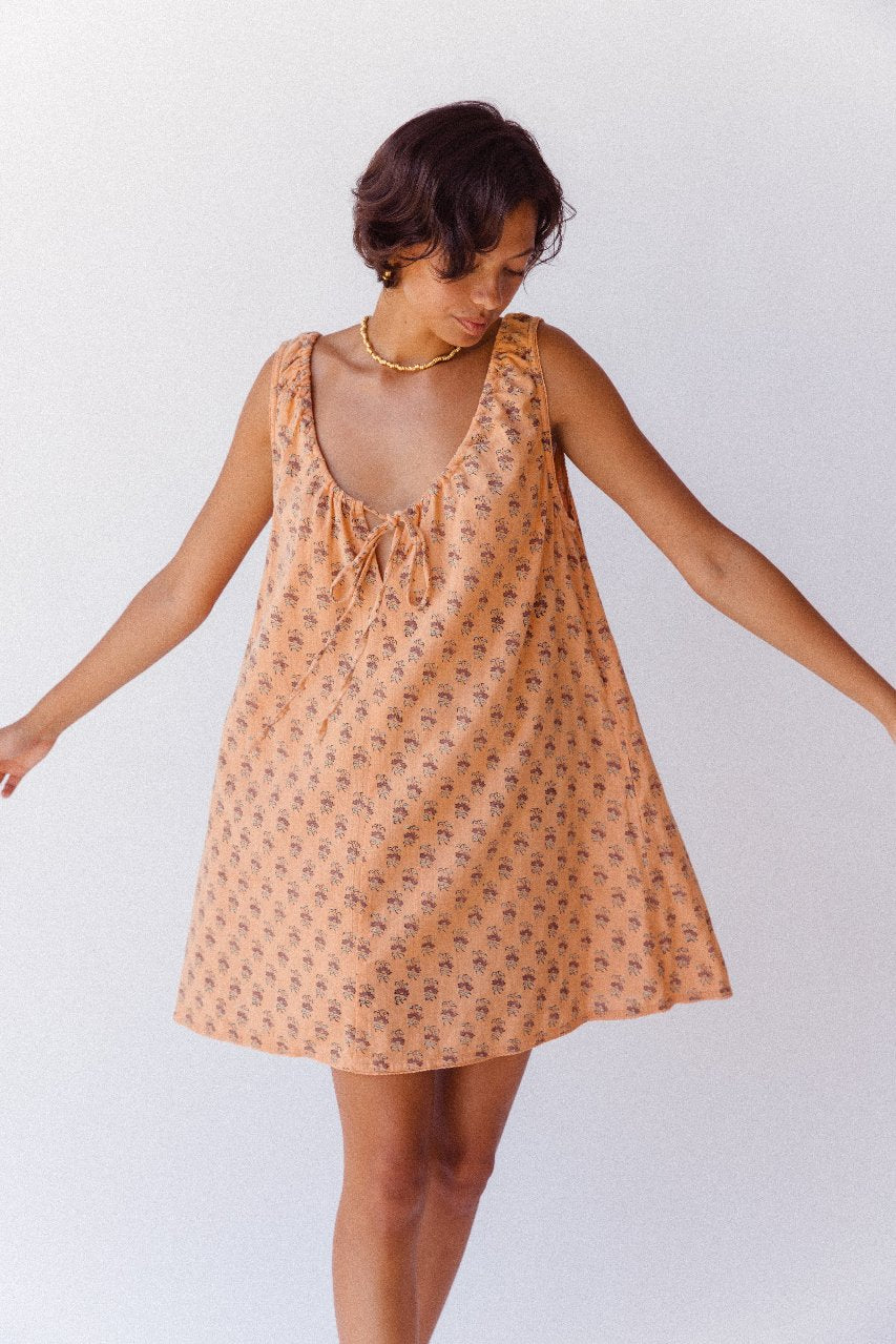 Sundress Mini Peach — fabric close-up detail, hand block print floral pattern on peach cotton, Sanganer Jaipur artisan printed textile, ethical sustainable fashion | Daughters of India