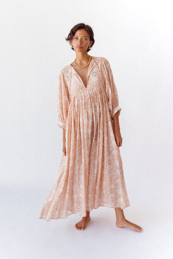 Daughters of India Kyra Maxi Dress in Apricot Blush — studio front view, V-neckline with gathered waist, gold necklace