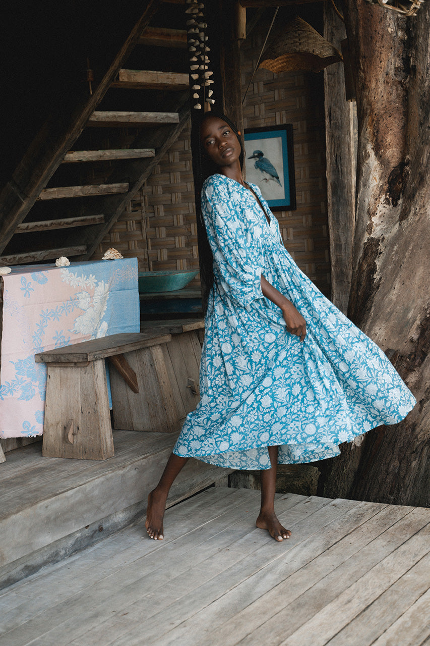 Daughters of India Kyra Midi Dress in Ocean Blue — twirling on wooden deck of treehouse, flowing hand screen print